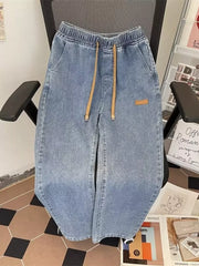 Light blue wide-leg jeans with drawstring waist and side pockets.