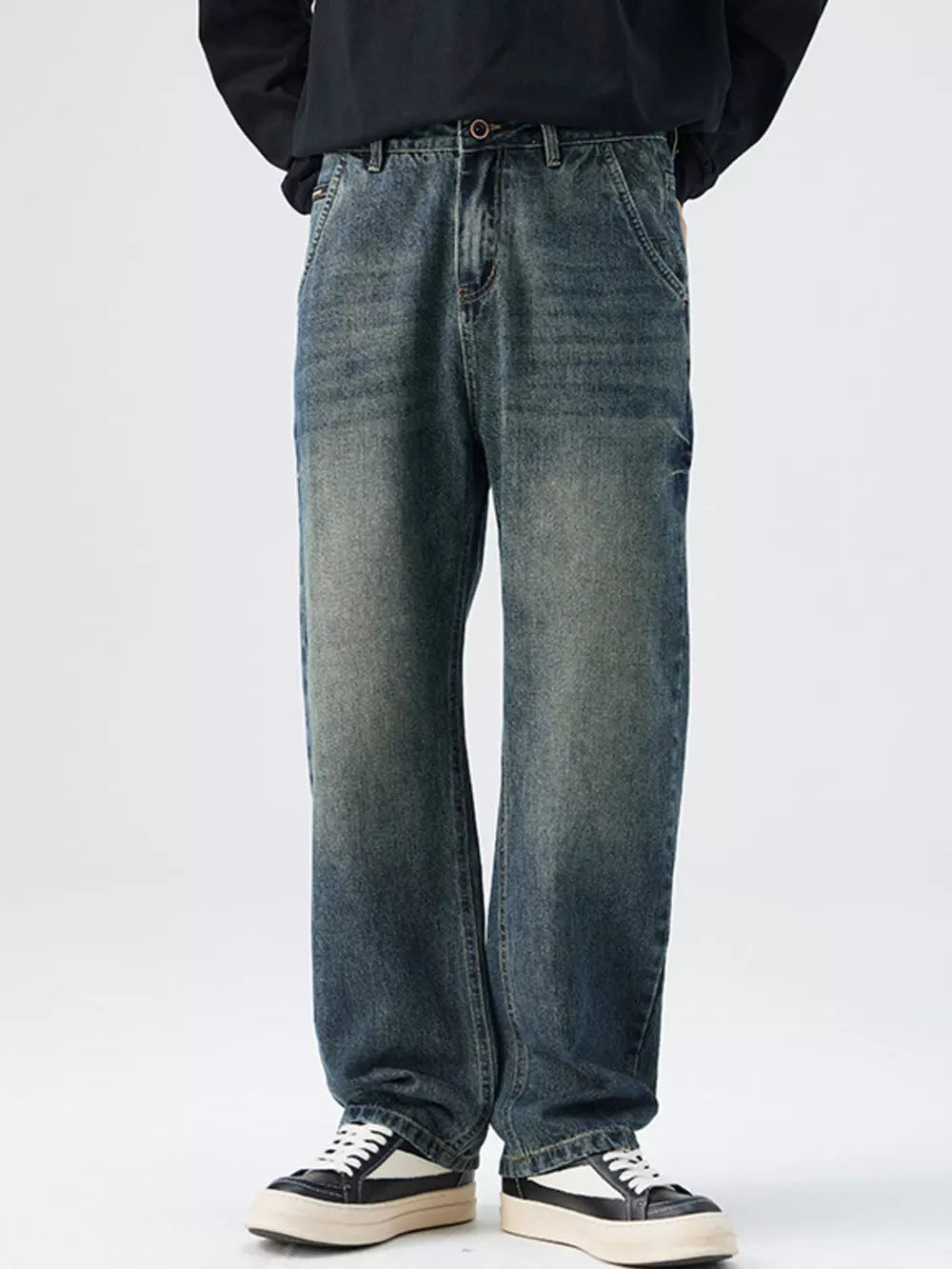 Men's relaxed fit vintage wash denim jeans with distressed details.