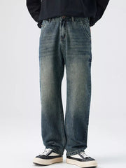Men's relaxed fit vintage wash denim jeans with distressed details.