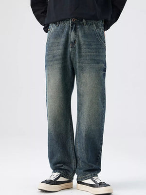 Men's relaxed fit vintage wash denim jeans with distressed details.