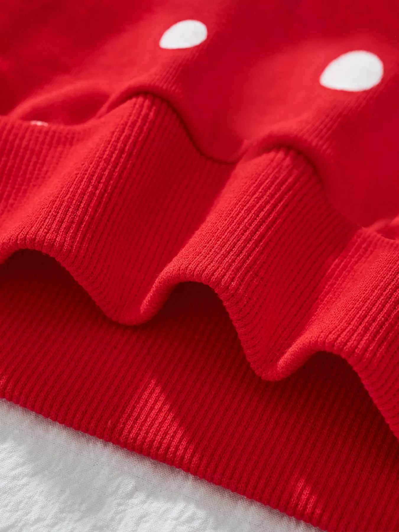 Red cotton sweatshirt with white polka dots and ribbed details