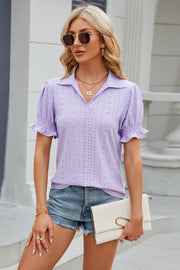 Lavender eyelet polo blouse with short puff sleeves and ruffled cuffs.