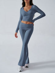 Dusty blue cross-front long sleeve crop top and flare lounge pants set.