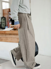 Men's wide leg trousers in taupe with a tie waist and pockets.