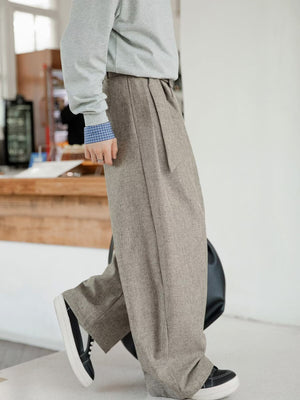Men's wide leg trousers in taupe with a tie waist and pockets.