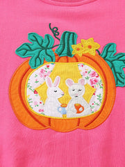 Pink cotton crew neck sweatshirt with pumpkin applique featuring two bunnies drinking tea.