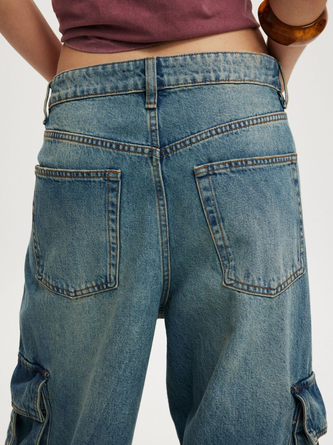 Relaxed fit cargo maternity jeans in light blue wash denim with vintage detailing.