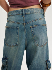 Relaxed fit cargo maternity jeans in light blue wash denim with vintage detailing.