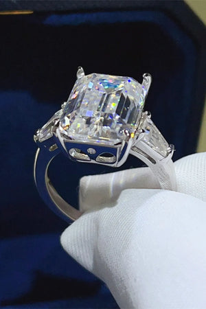 Silver ring with emerald cut moissanite and trillion side stones