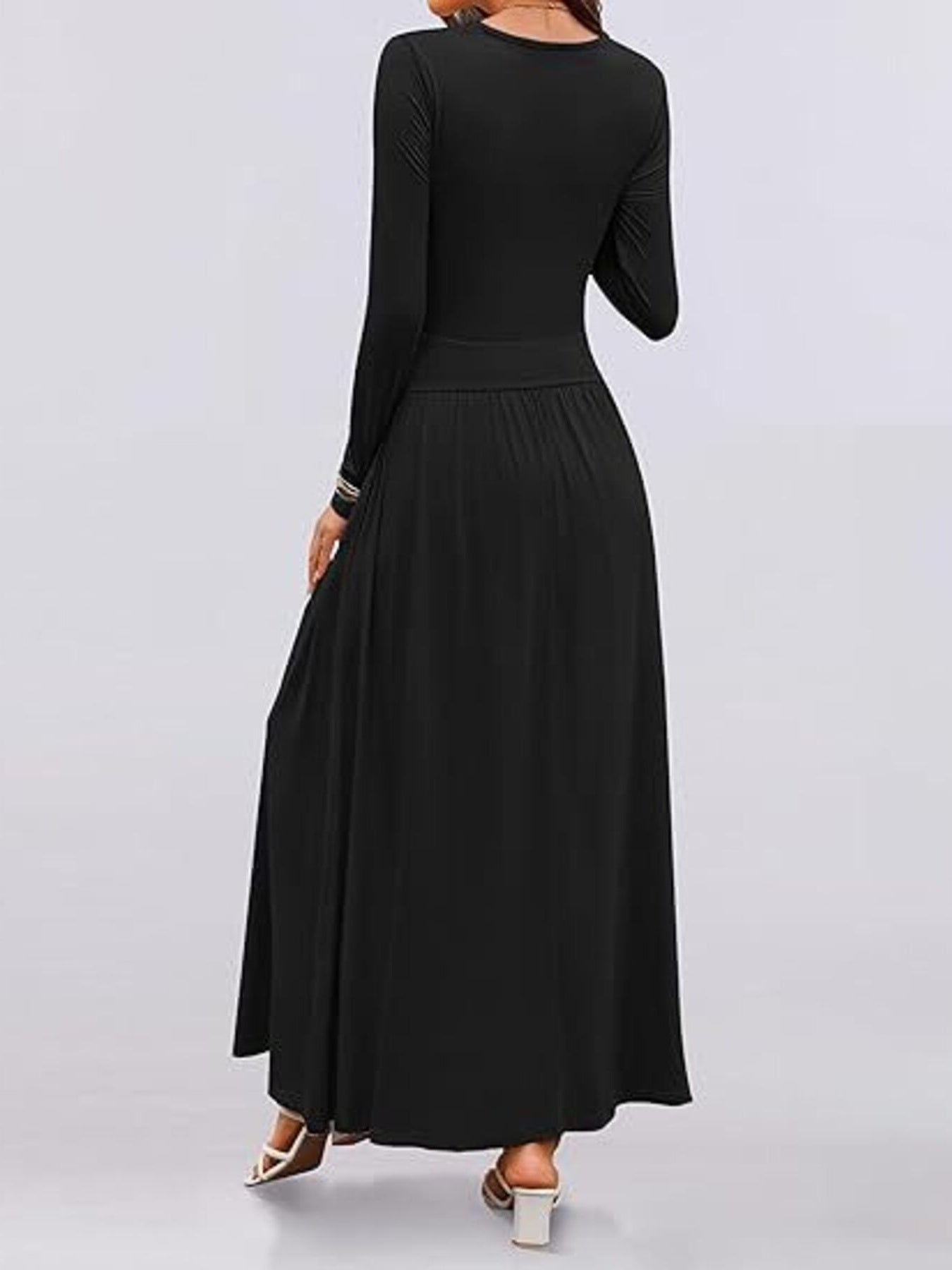 Black ruched maxi dress with long sleeves, empire waist, and pockets.