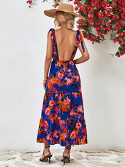 Blue abstract print tiered maxi dress with tie straps and open back.