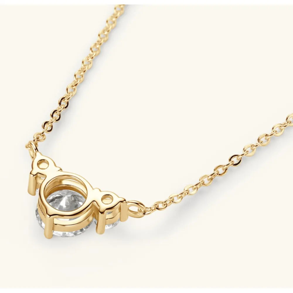 Gold diamond pendant necklace with a delicate chain and three round-cut stones.
