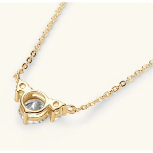 Gold diamond pendant necklace with a delicate chain and three round-cut stones.