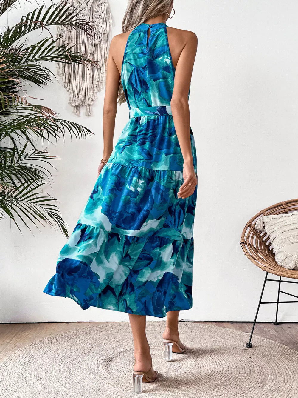Blue floral halter neck midi dress with tiered skirt and belted waist.