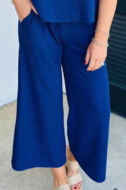 Royal blue textured culotte pants with cap sleeve top, shown on a model.