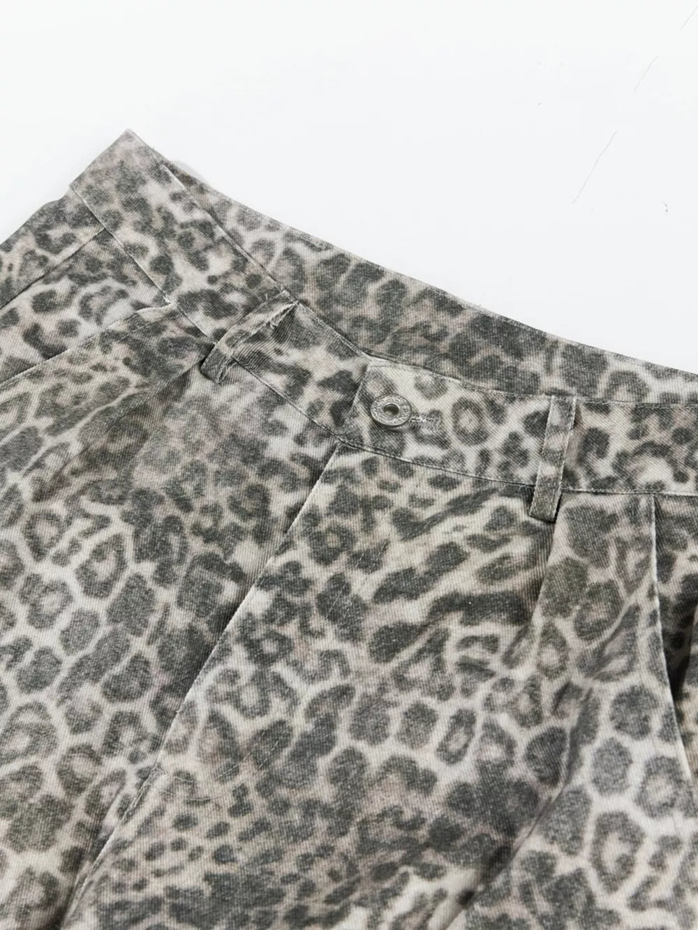 Leopard print cargo pants with button fly and utility pockets.