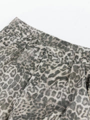 Leopard print cargo pants with button fly and utility pockets.