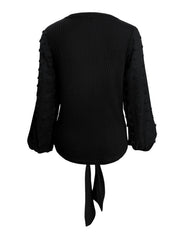 Black waffle knit blouse with swiss dot sleeves and tie front detail