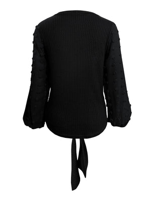 Black waffle knit blouse with swiss dot sleeves and tie front detail