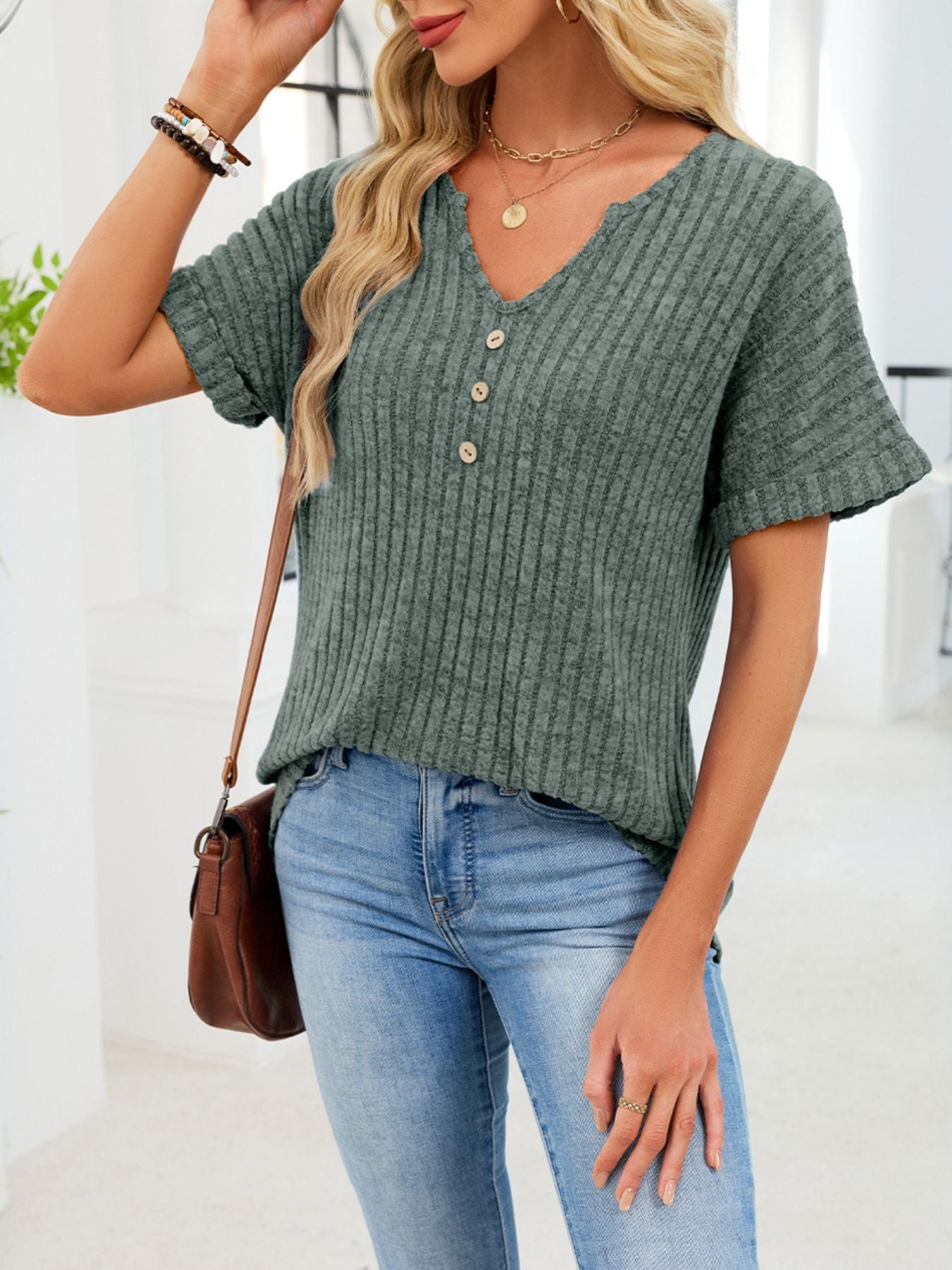 Ribbed knit short sleeve t-shirt in army green with decorative buttons and a notched v-neck.