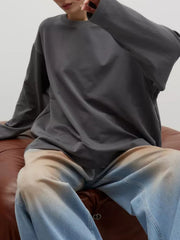 Dark gray oversized crewneck sweatshirt with voluminous sleeves.