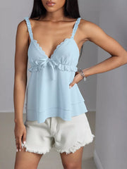 Light blue camisole with lace trim, ruffled layers, and a bow detail.