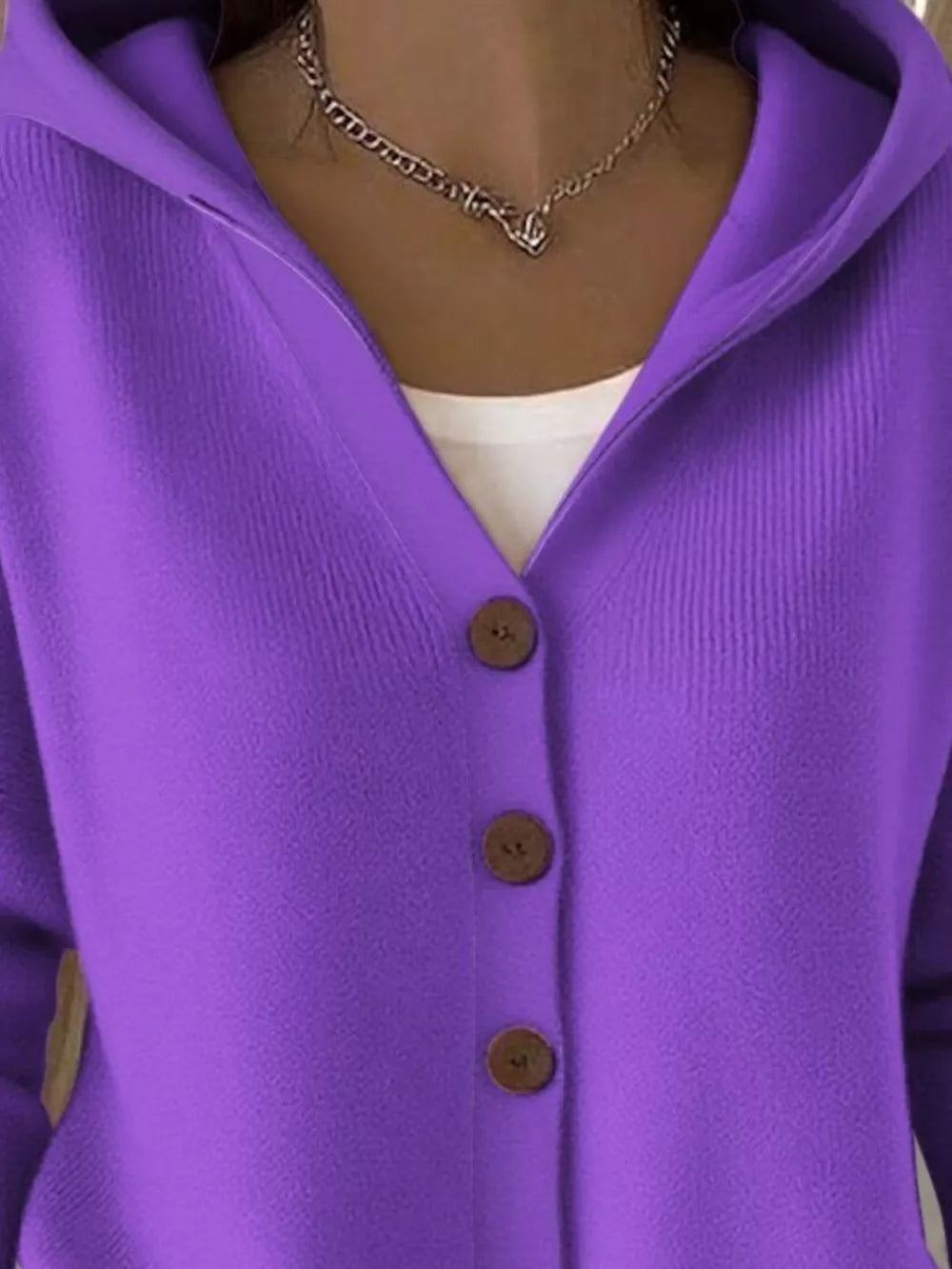 Purple hooded knit cardigan with button front and ribbed texture.