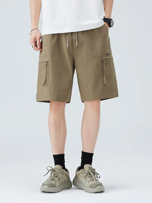 Men's camel cargo shorts with zippered pockets and drawstring waist.