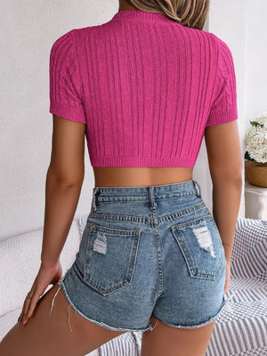 Hot Pink cable knit crop top with openwork detail and short sleeves.