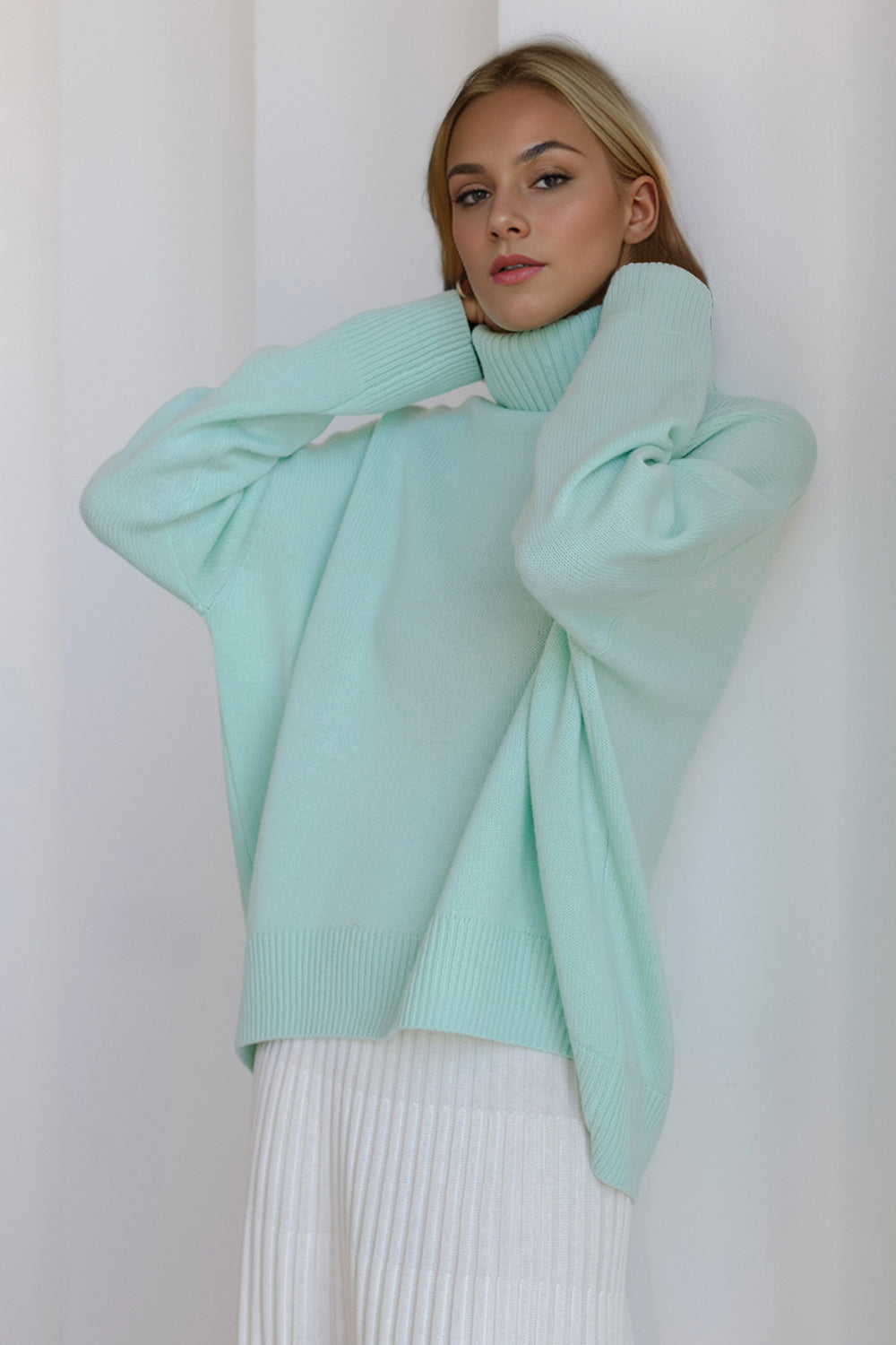 Oversized pastel blue cashmere turtleneck sweater with ribbed cuffs and hem.