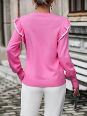Pink crew neck sweater with contrast trim ruffle shoulders and ribbed hem.