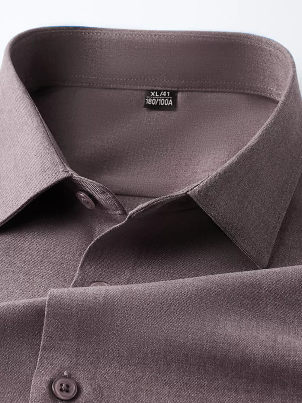 Men's brown long sleeve button-down shirt, close-up of collar and buttons.