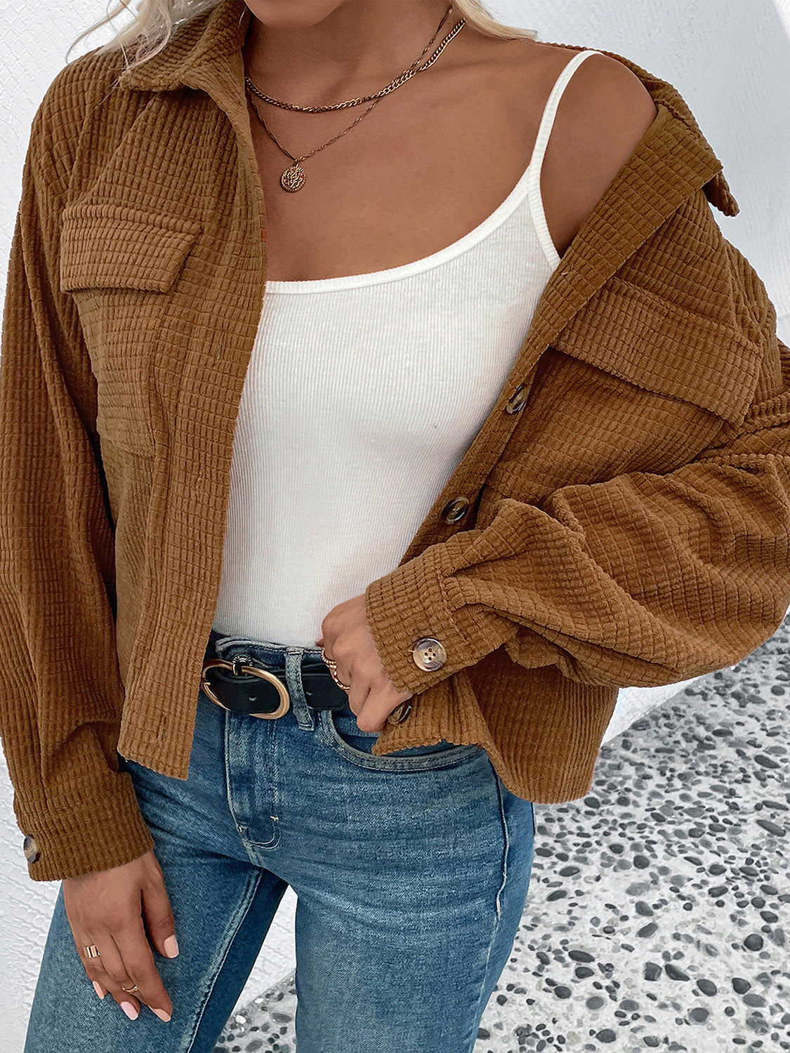 Textured corduroy cropped shirt jacket in camel with button details and chest pockets.
