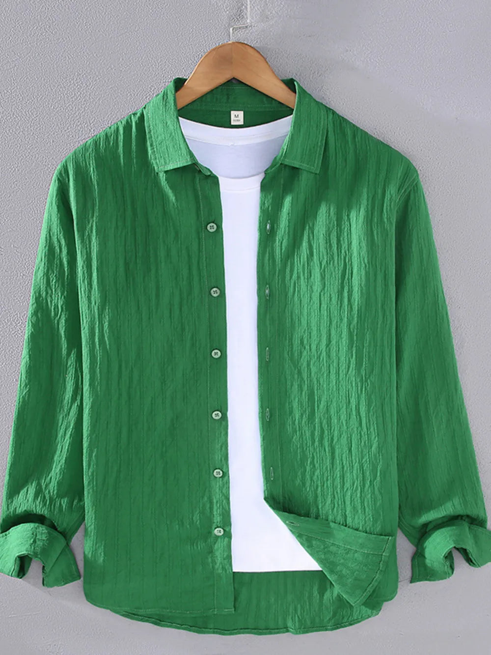 Green textured long sleeve button-up overshirt with classic collar and white t-shirt underneath.