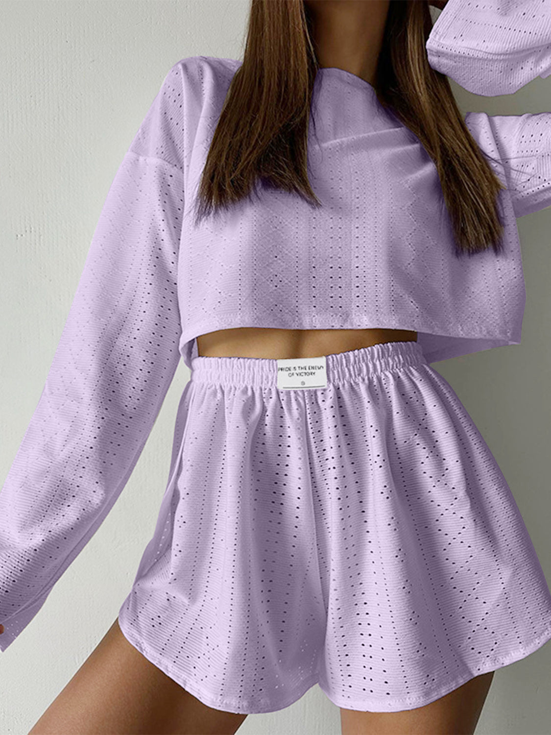 Lavender perforated crop top and shorts set with long sleeves and elastic waistband.