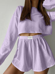Lavender perforated crop top and shorts set with long sleeves and elastic waistband.