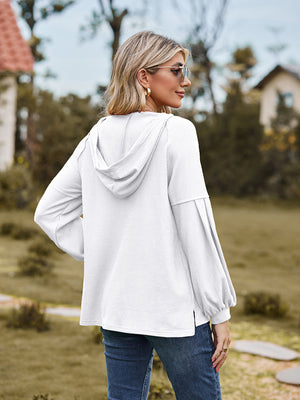 White ribbed hoodie with balloon sleeves and a hood, shown from the back.