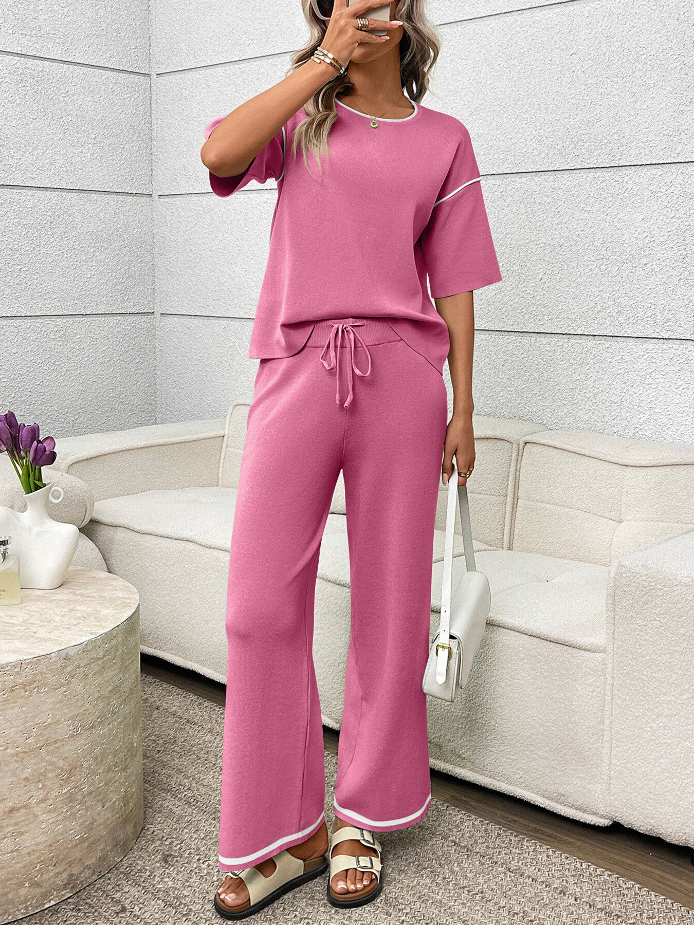Fuchsia pink loungewear set with crew neck top and drawstring pants, featuring contrast piping detail.