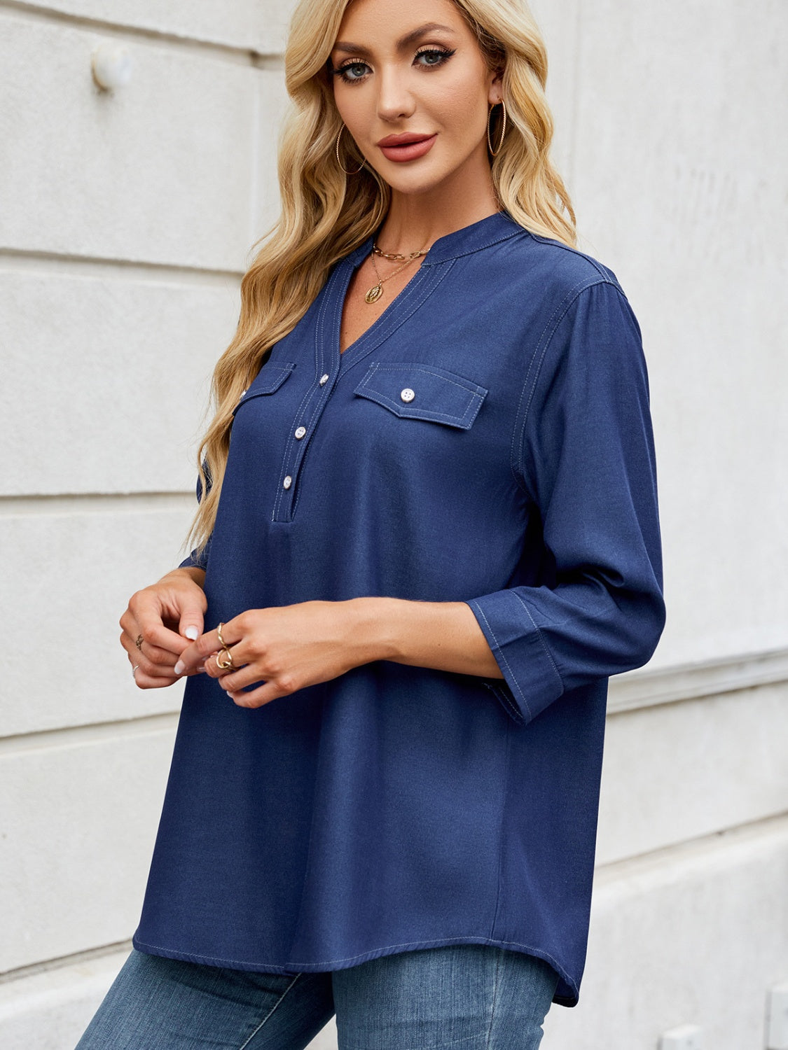 Dark navy denim henley blouse with V-neck, button placket, and two chest pockets.
