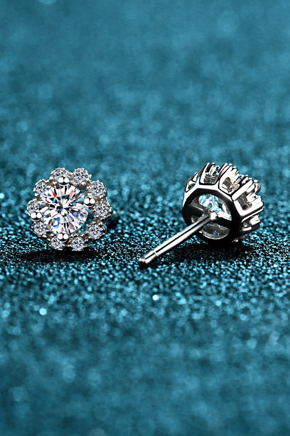 Floral halo stud earrings in silver, 925 sterling silver, with a central gem and surrounding smaller gems.