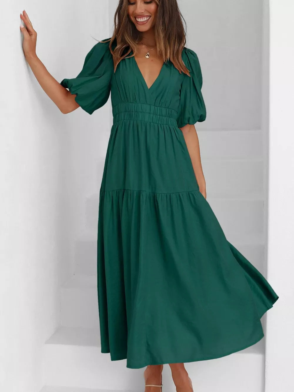 Green midi dress with puff sleeves, V-neck, cinched waist, and tiered skirt.