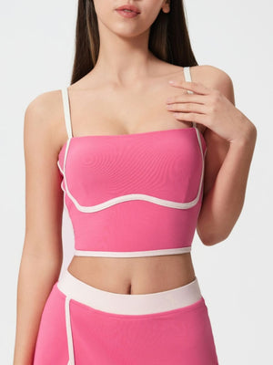 Fuchsia pink contour-trimmed crop top with white piping and sculpted bust.