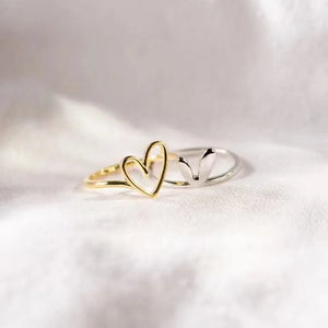 Gold two-tone heart outline ring with a delicate band.