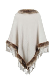Ivory textured knit poncho with faux fur trim and fringe details.
