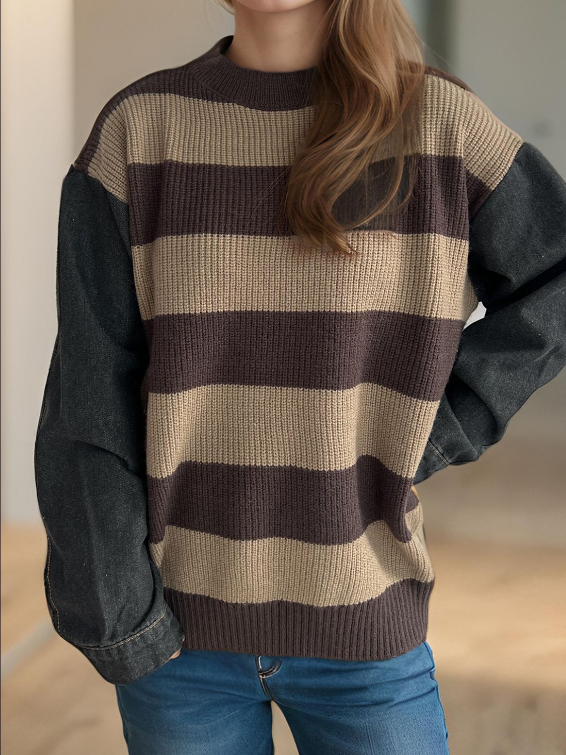 Denim sleeve stripe knit sweater with brown and tan stripes and a crew neck.