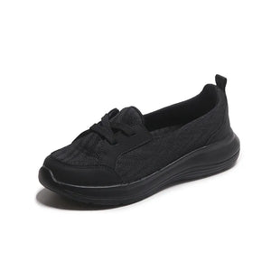 Black mesh and leather slip-on flats with a platform sole.
