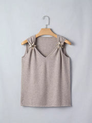 Light grey acrylic V-neck knit vest with star embellishments on shoulders.