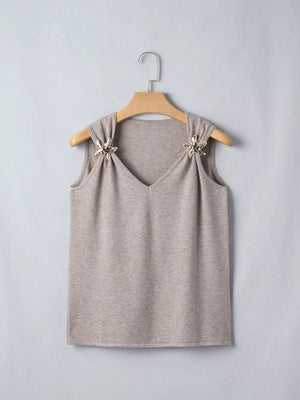 Light grey acrylic V-neck knit vest with star embellishments on shoulders.