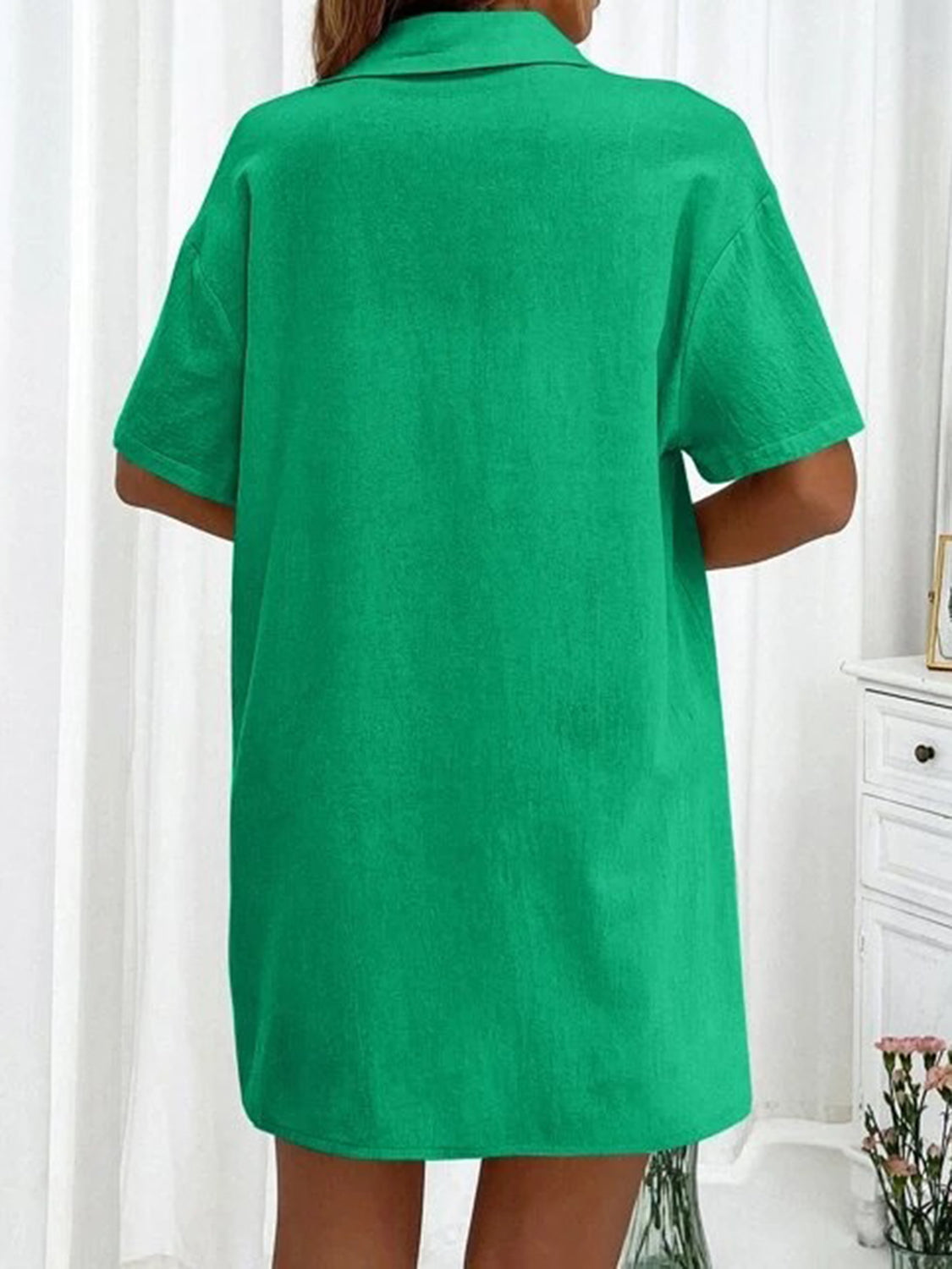 Green linen shirt with short sleeves and collar, back view
