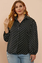 Black polka dot blouse with shirred balloon sleeves and a collared neckline.